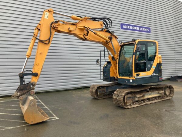 679a49915ed74_big_exp.jpeg Pelle à chenilles Hyundai R125 LCR-9A